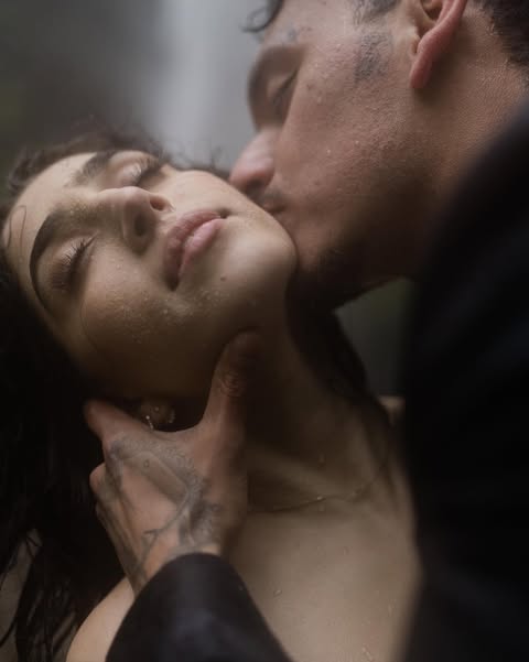 Intimate close-up of a couple with water droplets on their faces