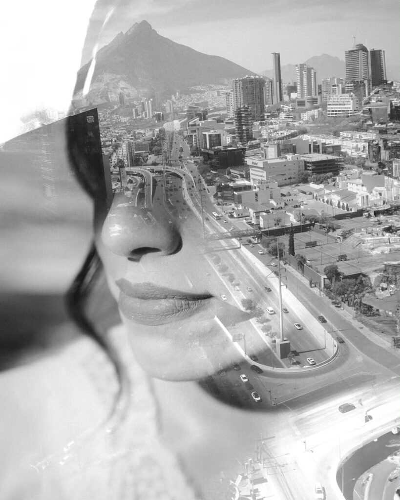 Black-and-white portrait layered visually with a city skyline and mountain