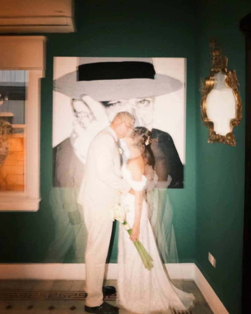 Layered portrait of a couple kissing in a green room beneath a framed picture