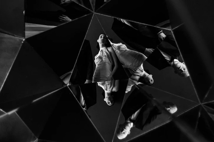 Bride reflected in angular mirror fragments in black and white