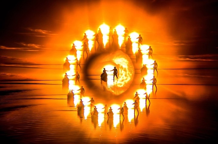 Couple at the center of a circular pattern of golden silhouettes