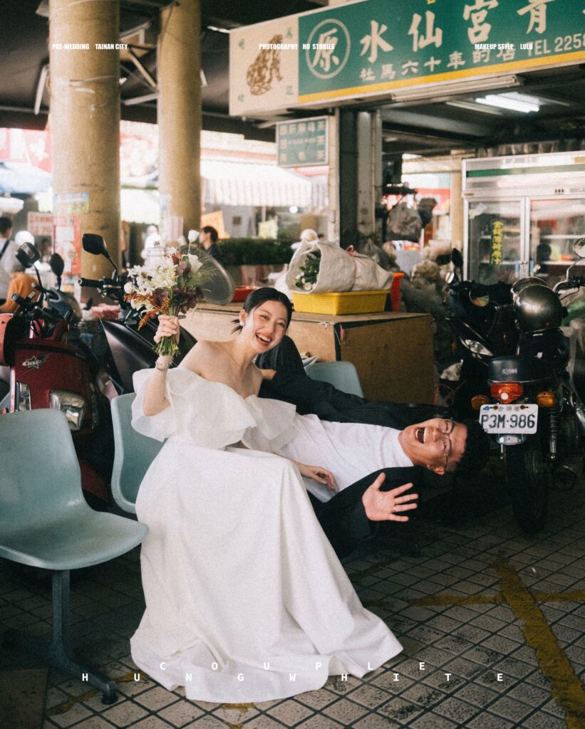 Playful seated couple portrait in a busy food hall