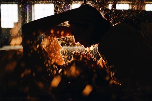 Close silhouette of a couple against sparkling golden light