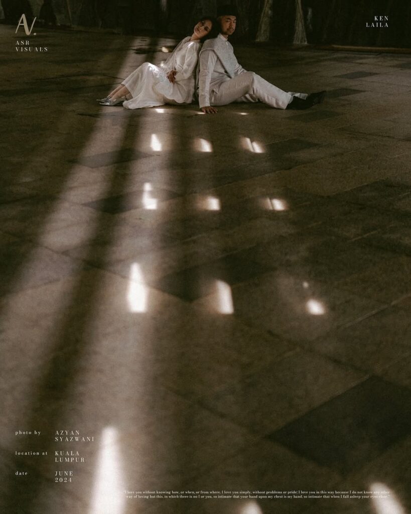 Wedding couple seated beyond long shadows stretching across a floor