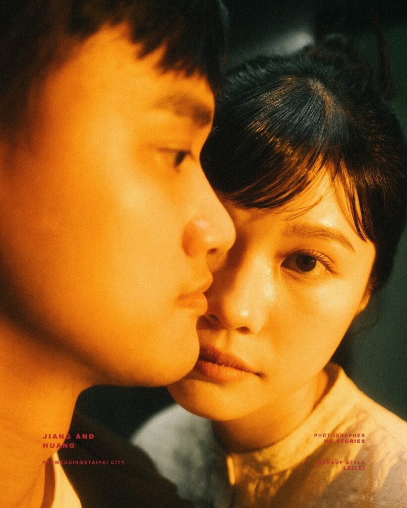 Close couple portrait in warm orange light, with one face in profile
