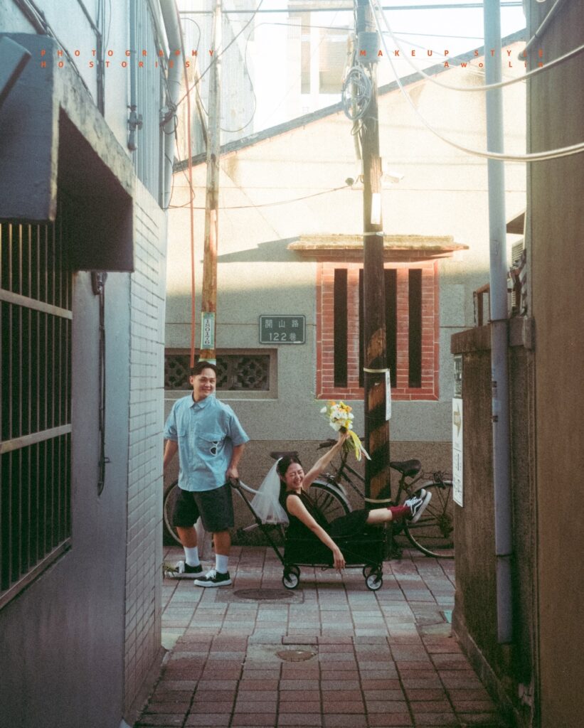 Casually dressed couple in a narrow sunlit alley with everyday objects