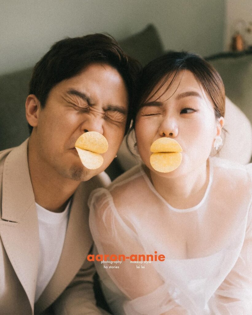 Wedding couple posing with crisps in their mouths