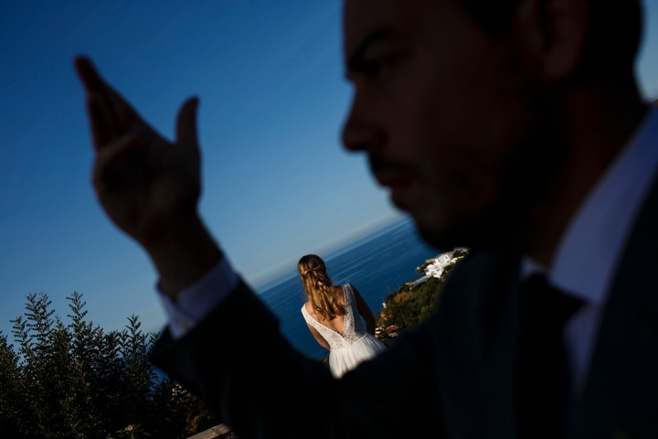 Portrait with a man close to the camera and a woman farther away under a blue sky