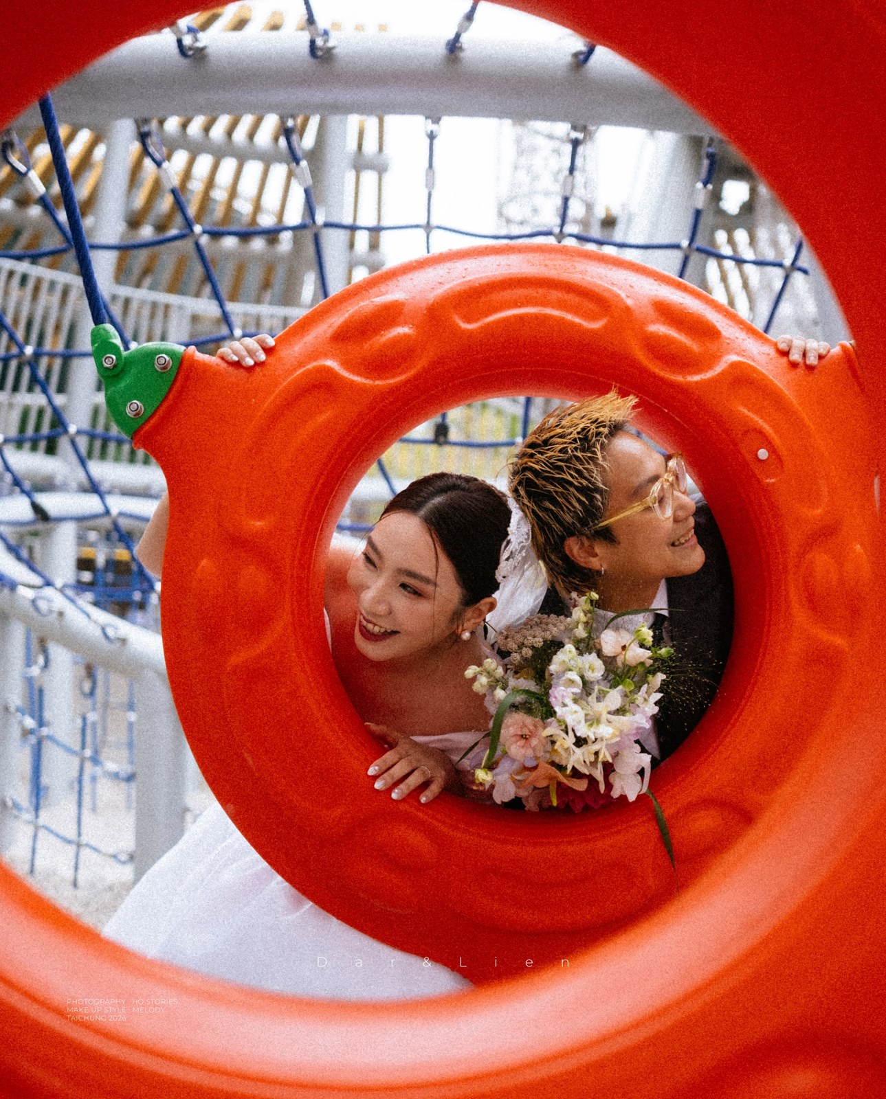 Laughing couple back to back inside a large orange playground circle