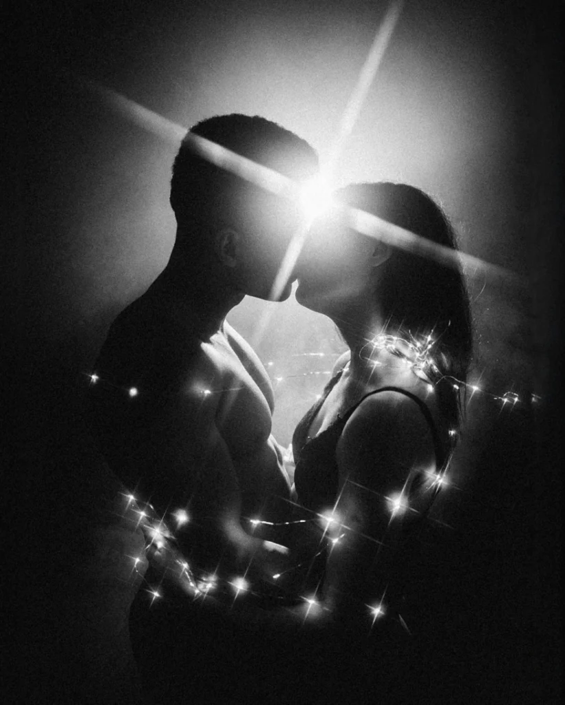 Monochrome couple portrait with a star-shaped highlight between their faces