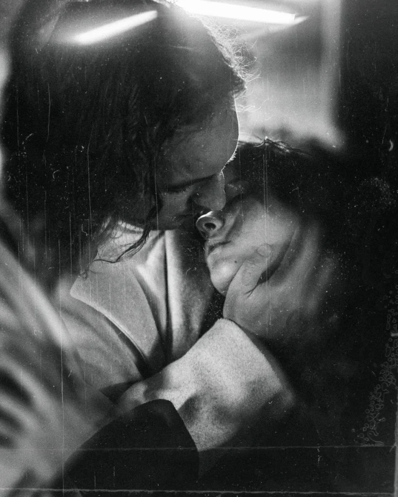 Black and white close-up of a couple resting their foreheads together